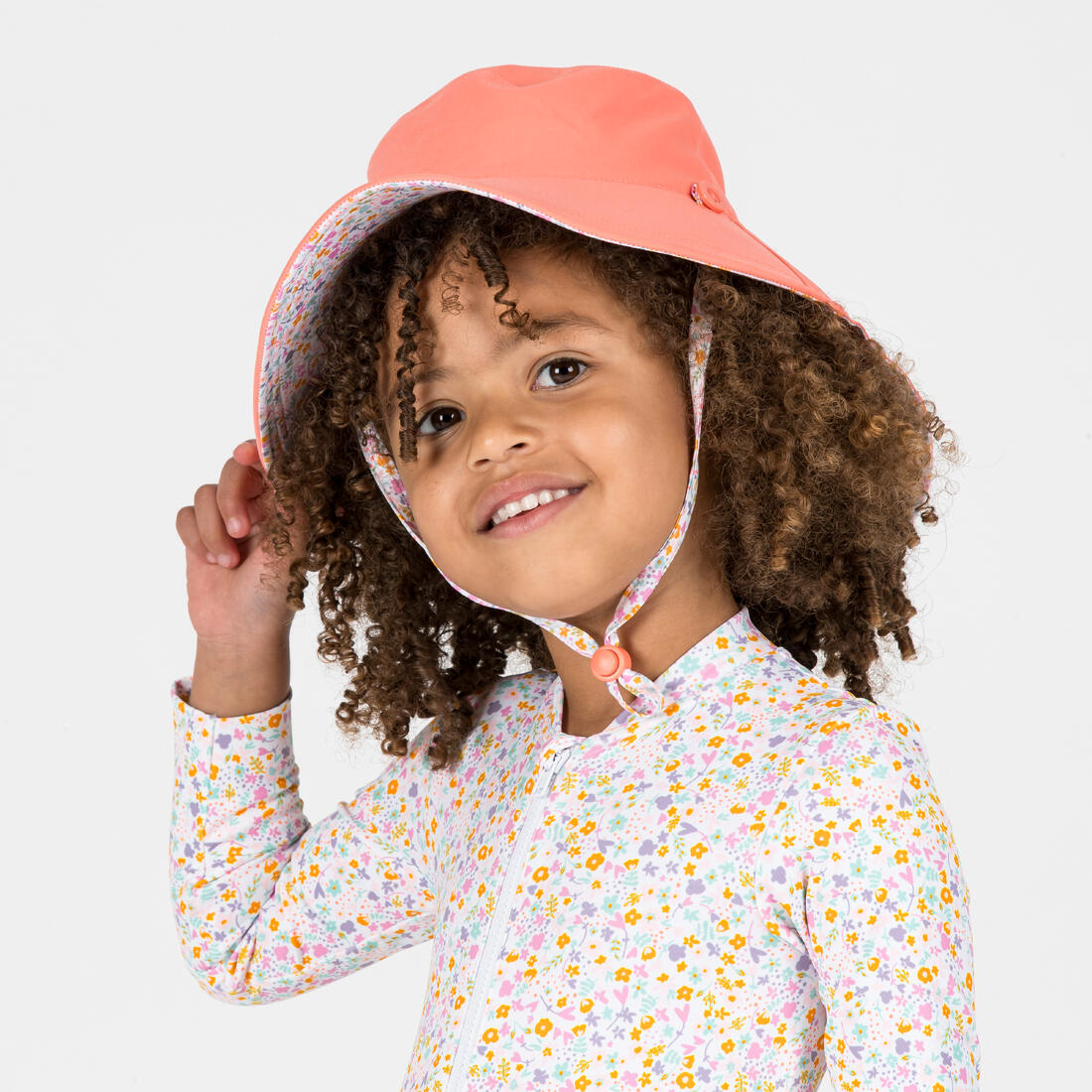 Chapeau anti uv bébé réversible rose clair et imprimé fleurs